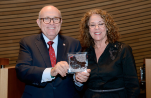 Former New York City Mayor Rudolph Giuliani holds a dove of peace plaque given to him by BGU President Prof. Rivka Carmi. Photo by Dani Machlis/BGU